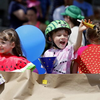 JASON HUNTER n WATERTOWN DAILY TIMES
Olivia Sommerstein, left and Miles Attemann, wave from the Nature's Storehouse float Saturday during the annual Dairy Princess Festival Parade in downtown Canton.